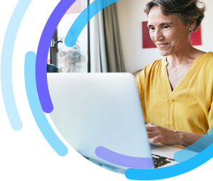 Image of a woman sitting and working on a laptop