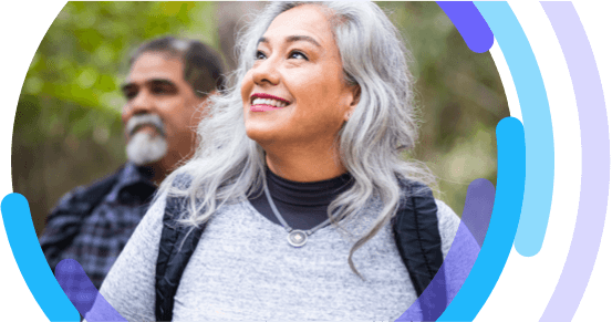 Woman walking a with a man, both are wearing backpacks