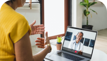 Image of a woman on an telehealth call with a healthcare professional on a laptop