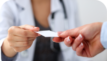 Image of one hand passing a GVHD medical alert card to another hand