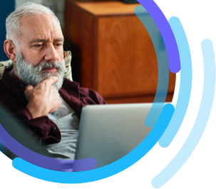 Image of a man reading on a laptop