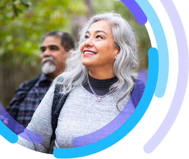 Woman walking a with a man, both are wearing backpacks