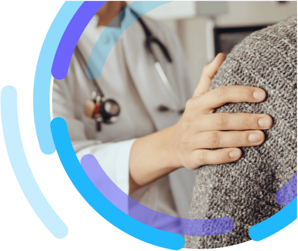 A heathcare professional's hand resting on a patient's shoulder