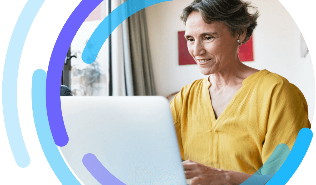 Image of a woman in yellow shirt looking at a laptop