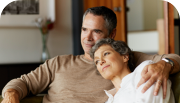 A man and a woman sitting on a sofa together