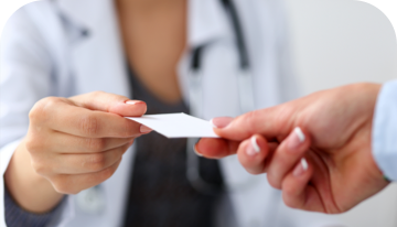 Image of one hand passing a GVHD medical alert card to another hand