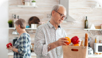 Image of a man and woman unpacking groceries in a kitchen