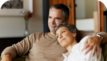 A man and a woman sitting on a sofa together