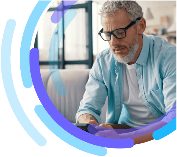 Man sitting on sofa looking at smartphone