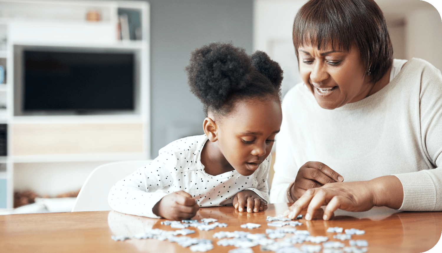 Woman and girl working on a puzzle together