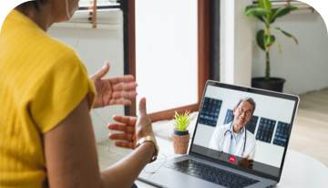 Image of a woman on an telehealth call with a healthcare professional on a laptop