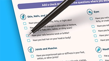 Image of cGVHD symptom assessment form and pen